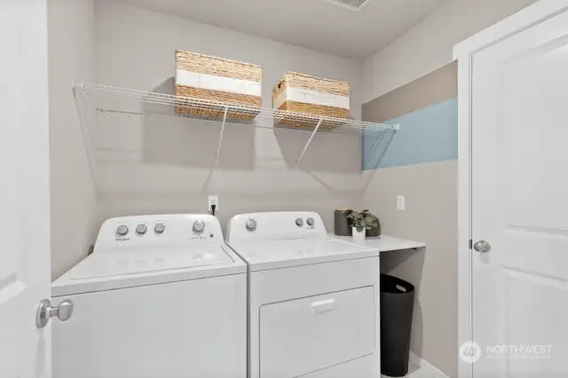 Spacious laundry room located on upper level with lots of storage. Photos are for representational purposes only. Colors and options will vary