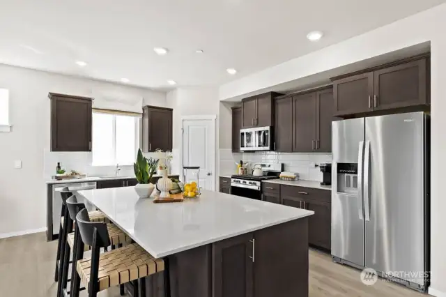 Chef-inspired kitchen with large center, Stainless steel appliances and an abundance of storage. Photos are for representational purposes only. Colors and options will vary