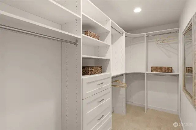 Maximize organization with this custom-designed walk-in closet. Its built-in shelving and ample hanging space ensure that everything has its place, offering a blend of practicality and elegance.