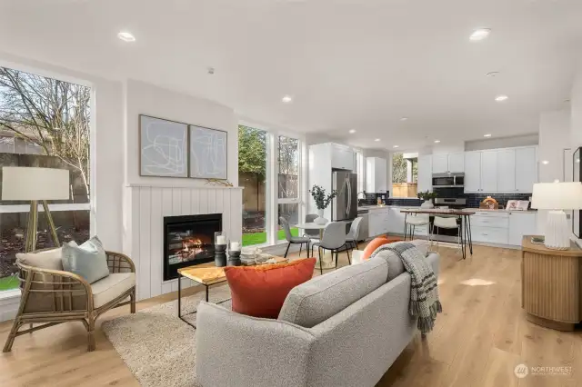 An open floor plan connects the living room, dining area, and kitchen, making this space ideal for entertaining and everyday living. The modern finishes and abundant light elevate every moment spent here.