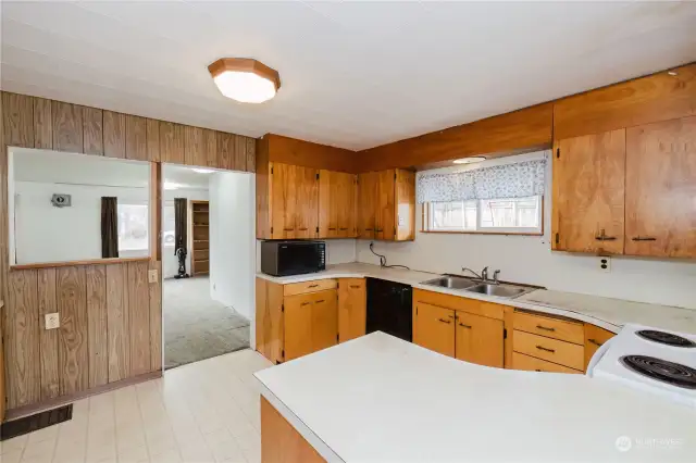 The kitchen has nice access to the living room, maybe remove the wall for a great room effect.