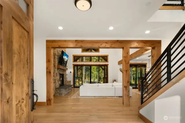 Vaulted ceilings in the main living space anchored by a large stone fireplace.