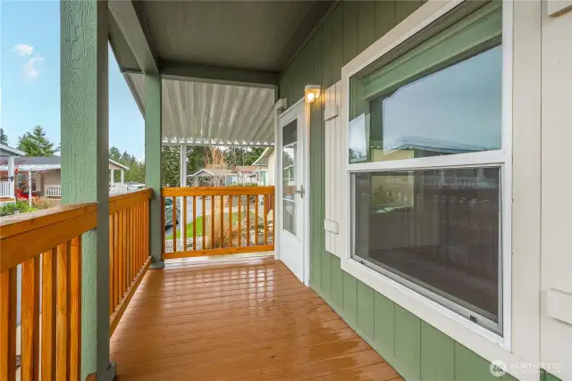 Front Porch: Relax on your charming covered front porch with wood railing.