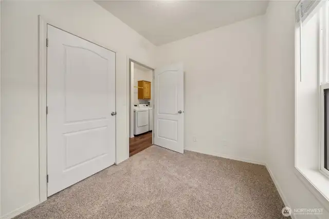 Second Bedroom: Cozy guest room or office with natural light.