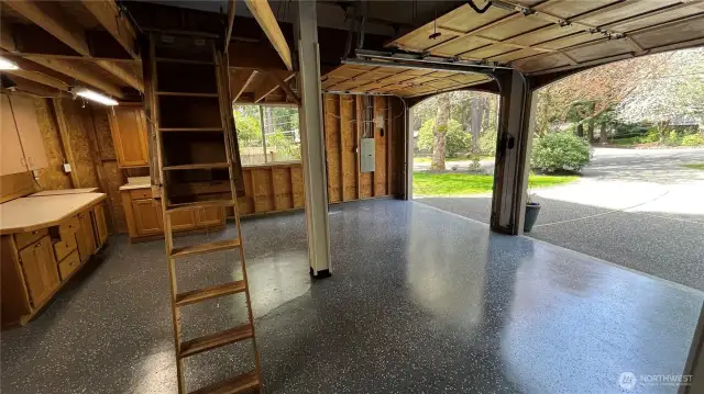 Spacious 2-car garage with 8 ft tall doors and storage loft