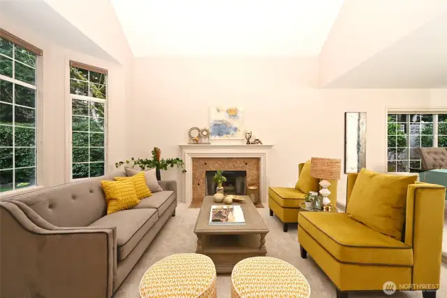 a vaulted ceiling and bay window create formal elegance in the living room,