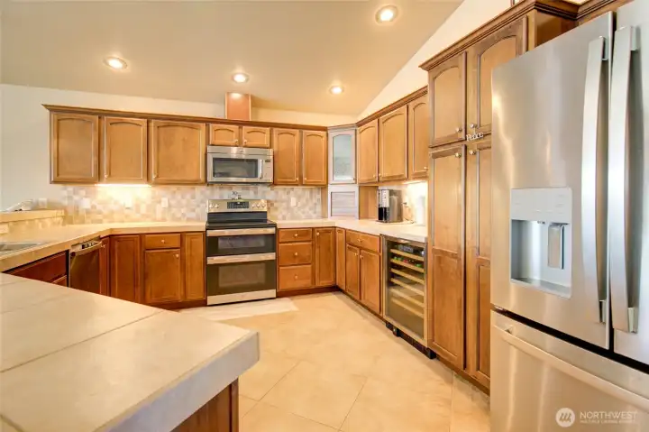 Kitchen features beautiful cabinetry, with a large pantry cabinet for additional storage space, and a built in wine fridge!