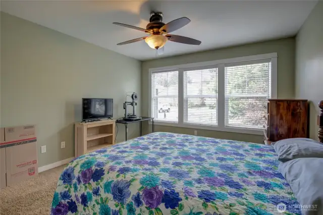 Nicely sized room looks over the front lawn and trees.