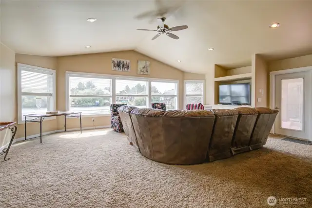 A closer look at the living room shows the vaulted ceilings and large windows.