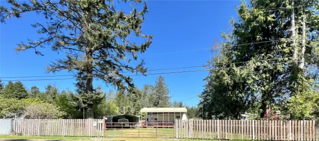 Large fenced in lot with 29ft RV under a RV Port, fully furnished with all you need. Just bring your clothes.