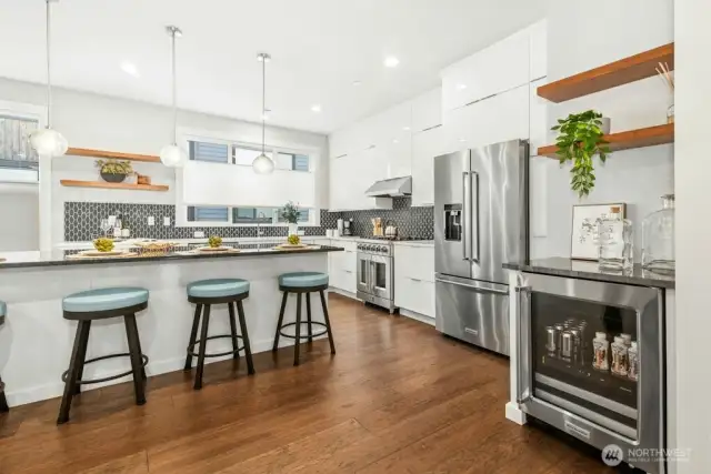 Luxury kitchen with beverage fridge and bar shelving, Forno french door range and gas cooktop