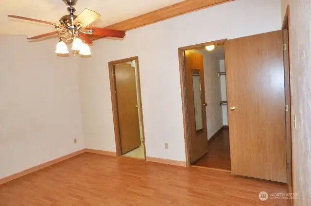 Another view of the primary bedroom. First door leads to walk in closet and 2nd door is to the primary bathroom.