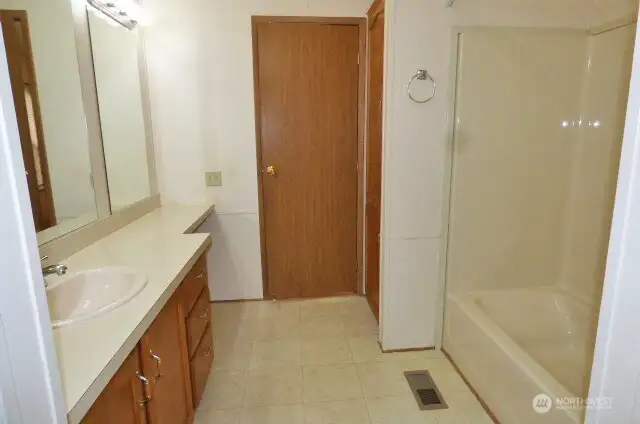 Primary bathroom with a linen closet.