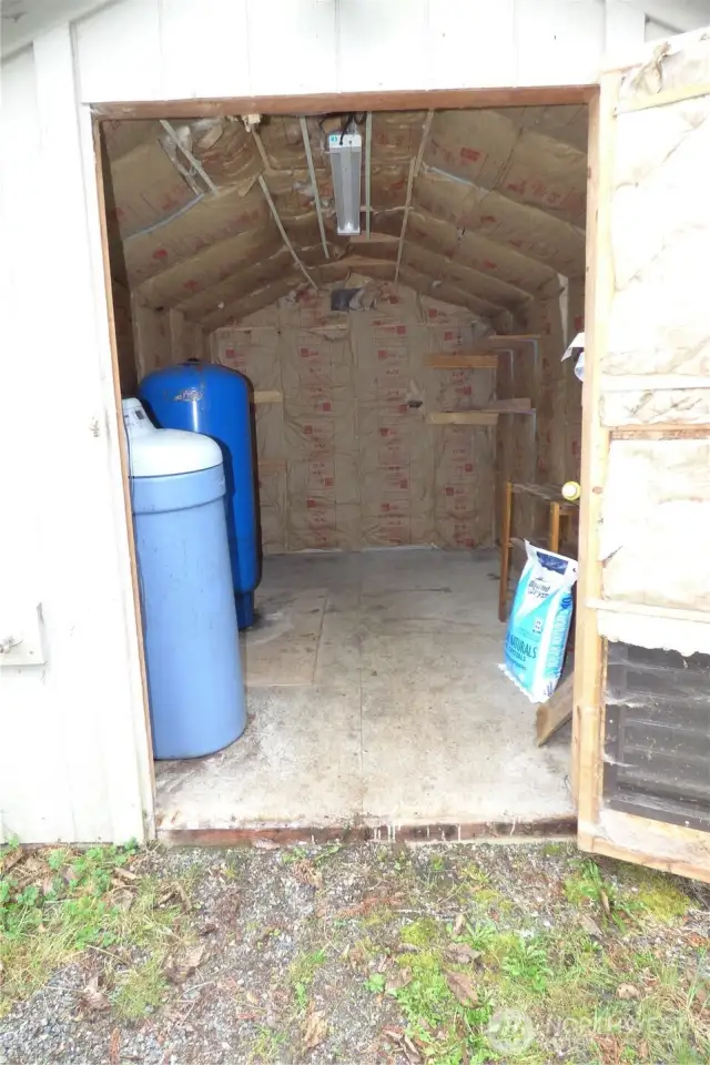 Inside shed has electricity and well components.