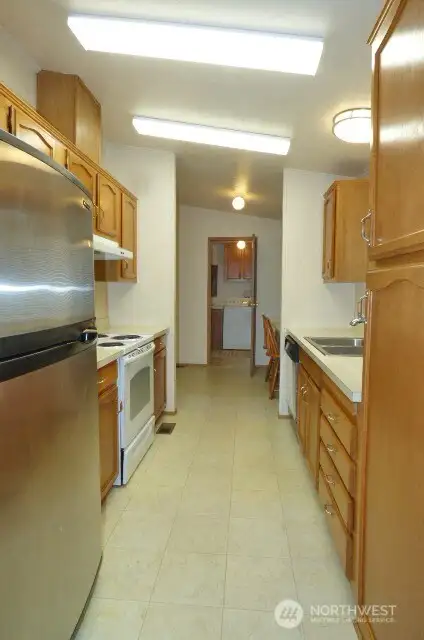 Another view of the kitchen through the 'den' area to the laundry.