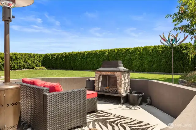 Fireplace sitting area and privacy shrubs.