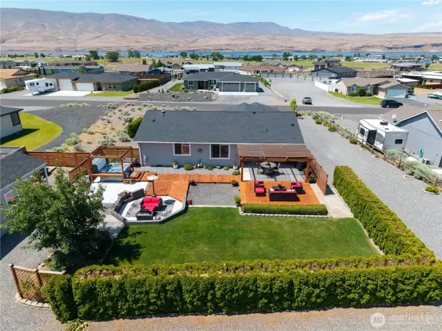 Aerial view of back of home. RV parking and RV hookups.