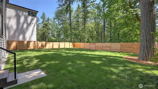 Just steps down from the deck and Main Level, relax to the serenity of the wonderful backyard.