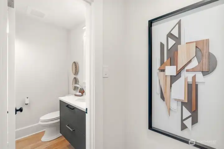 The main floor half bath is very private as it is hidden behind custom door.