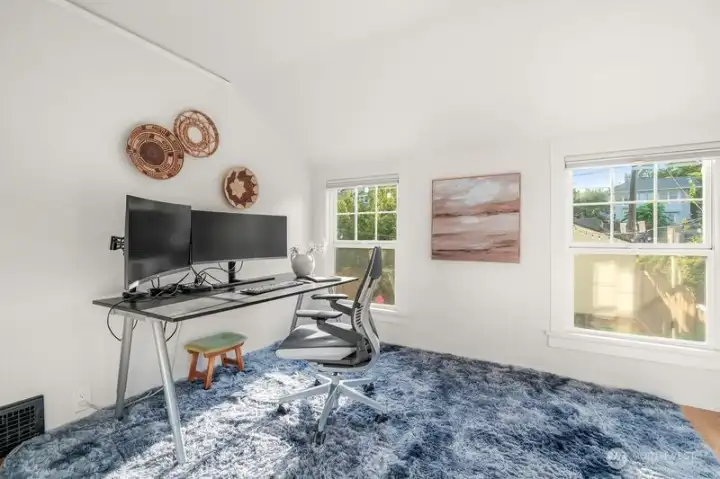 This 3rd bedroom is staged as an office. Great natural light as it overlooks the backyard as well.