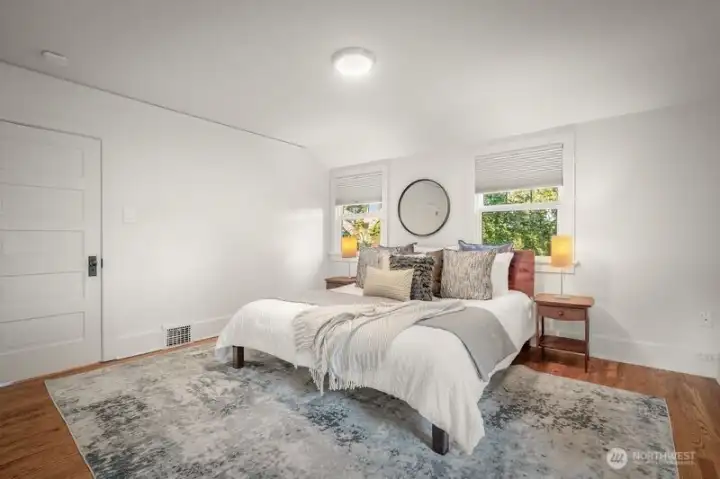 The primary bedroom has the pretty evergreen trees outside the windows- very quiet and peaceful place to slumber. Also has morning light.