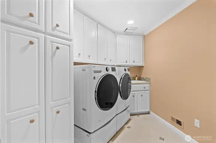 This dedicated laundry room not only provides amazing storage for this common chore, but aids in efficiency and organizational purposes.