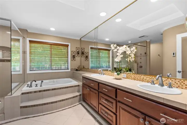 Your private, spa-inspired oasis. Escape into relaxation with this dual vanity, tiled stepped tub, and heated floors!