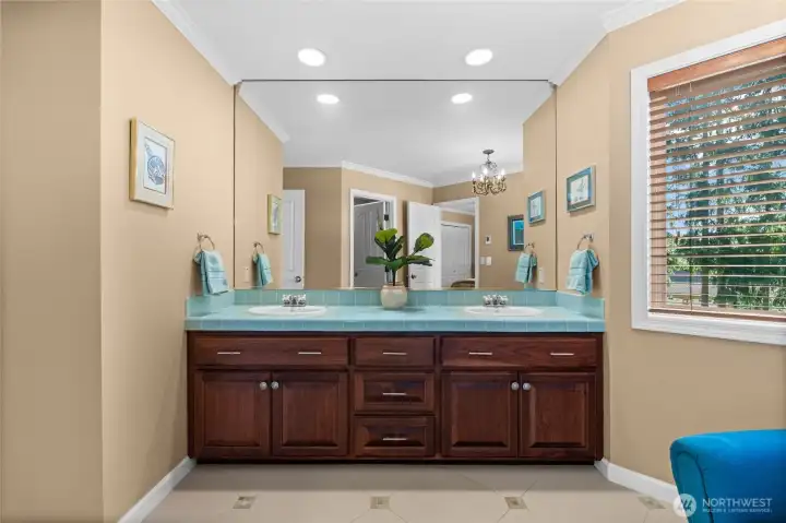 Gorgeous shared bathroom with accented blue tile work and heated bathroom floor. Soak up this serene, bright, and clean atmosphere.