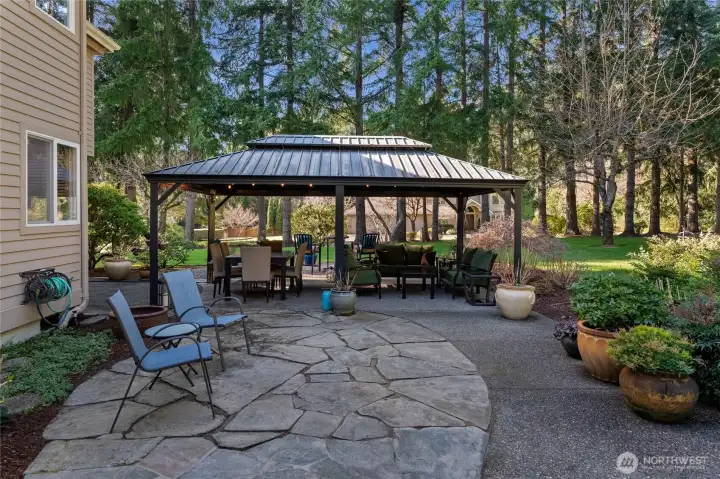 Beautifully designed with flagstone pavers, this outdoor walkway is perfect for exploring what this backyard has to offer.