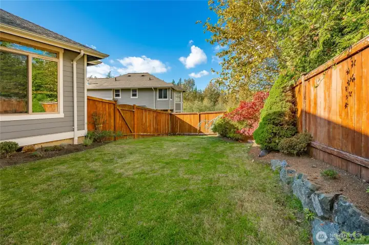 Fenced yard backs onto greenbelt