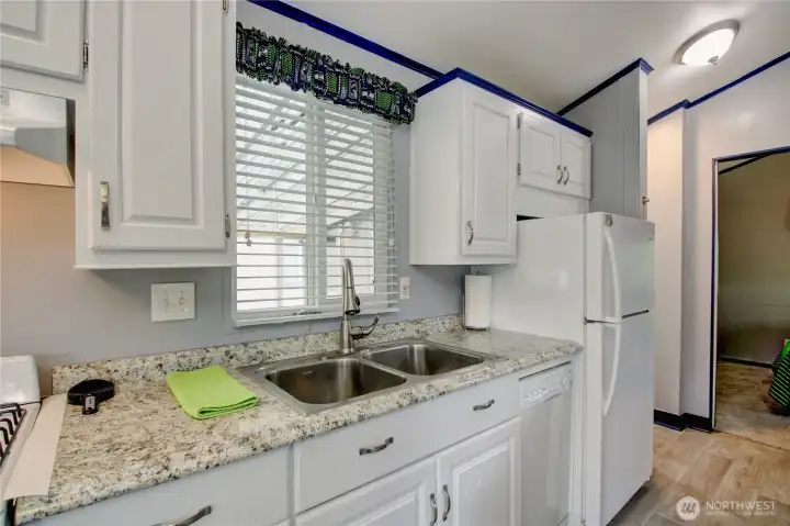 Spacious kitchen offers an abundance of cabinetry and full sized double sinks