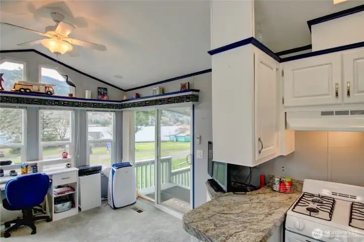 Spacious living room with slider door to large deck.