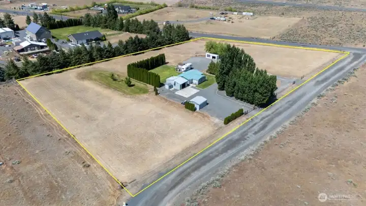 Nearly 4 Acres with 2 shops, outbuildings, rv hookups, open space and more!