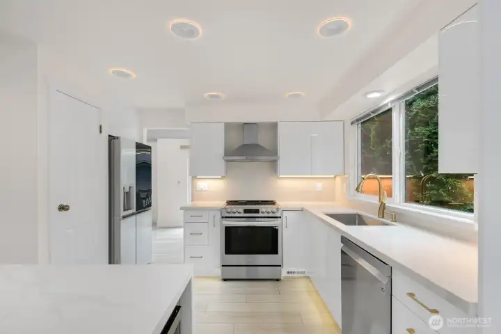 Kitchen Toward Dining Showing Smart Fridge and Night Light Mode on LED Ceiling Lights