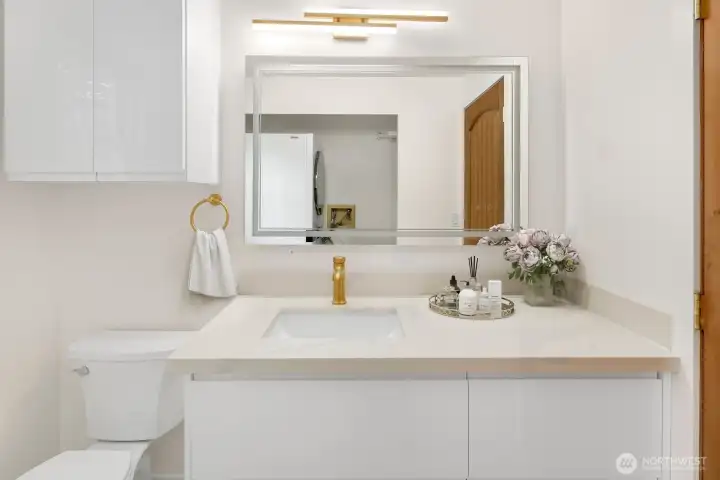 Refinished Half Bath on Main Level - Contemporary Cabinets, Upgraded Lighting, Slab Quartz Counters with Undermount Sink and Touchless Faucet - Virtually Staged