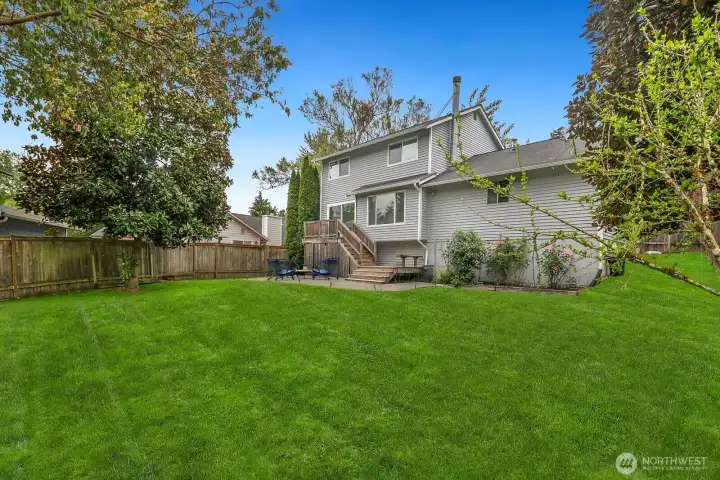 Fully-fenced Backyard Features Expansive Lawn, Mature Plantings, Patio, Deck and Territorial Views