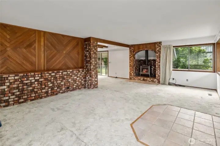 Anchored by warm brick and a cozy fireplace, this living space was built for gathering.
