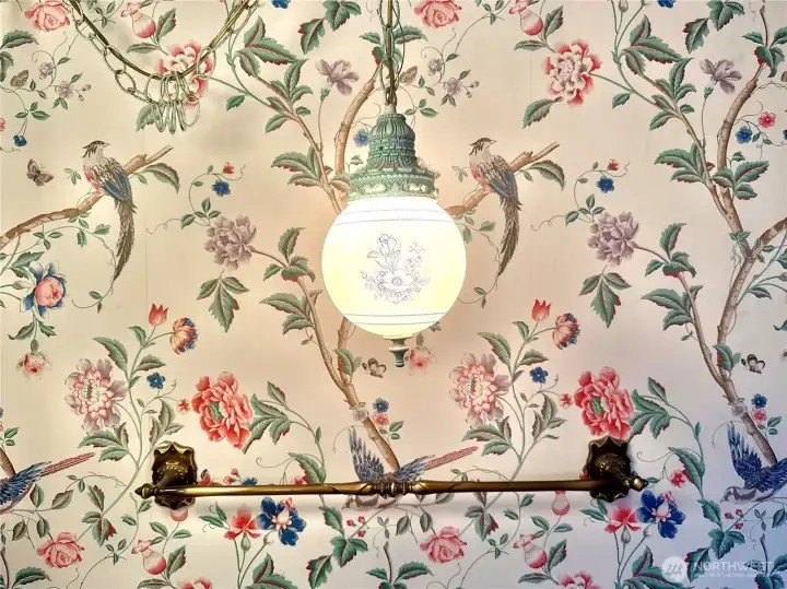 The delicate blue florals on the hanging lights look perfect with the floral and bird wallpaper.