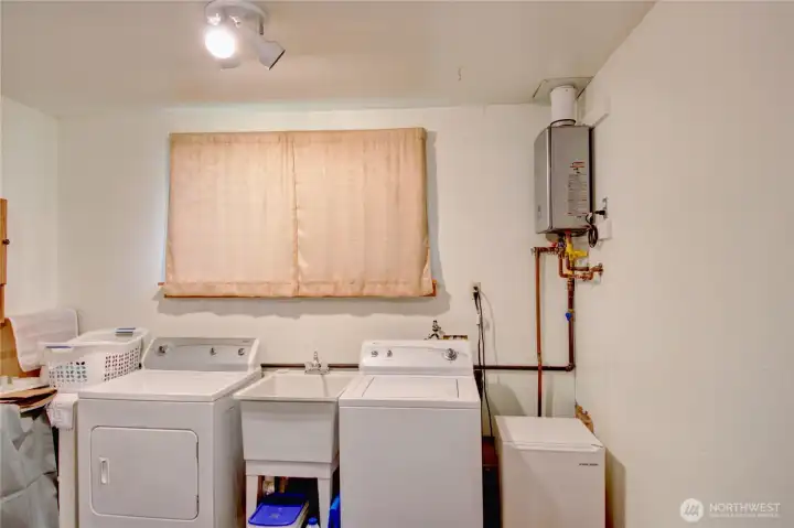 Washer, dryer and on-demand hot water located in attached garage with window and utility sink. Washer, dryer and on-demand hot water located in attached garage with window and utility sink.