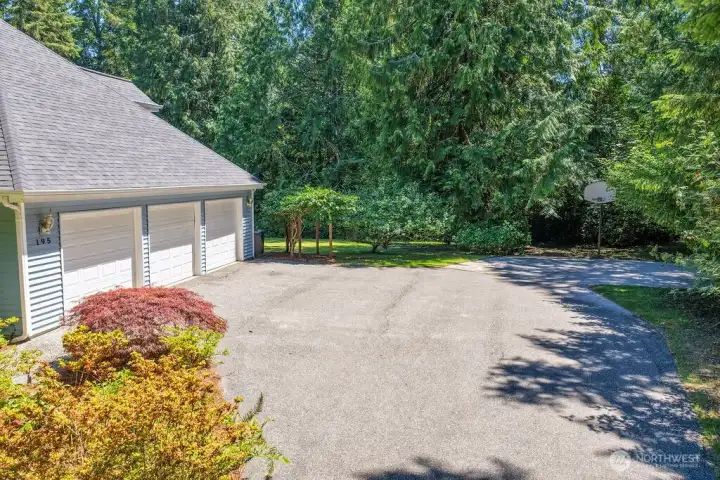 3 car garage and basketball play area Also, electric vehicle charging is available.