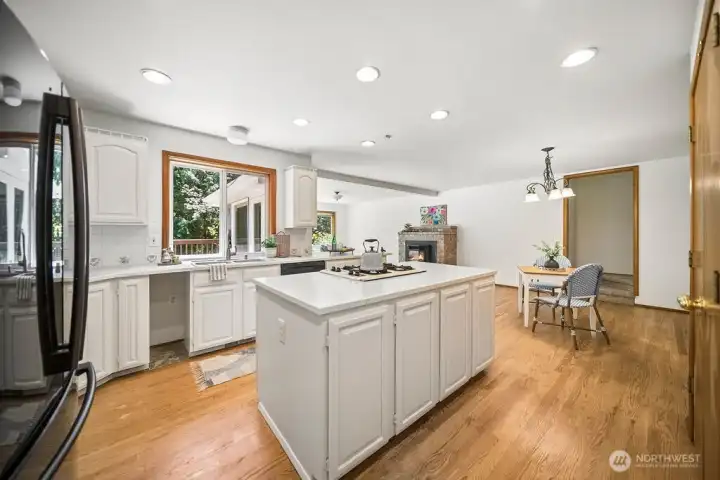 Hardwood floors adorn this eat in kitchen area.
