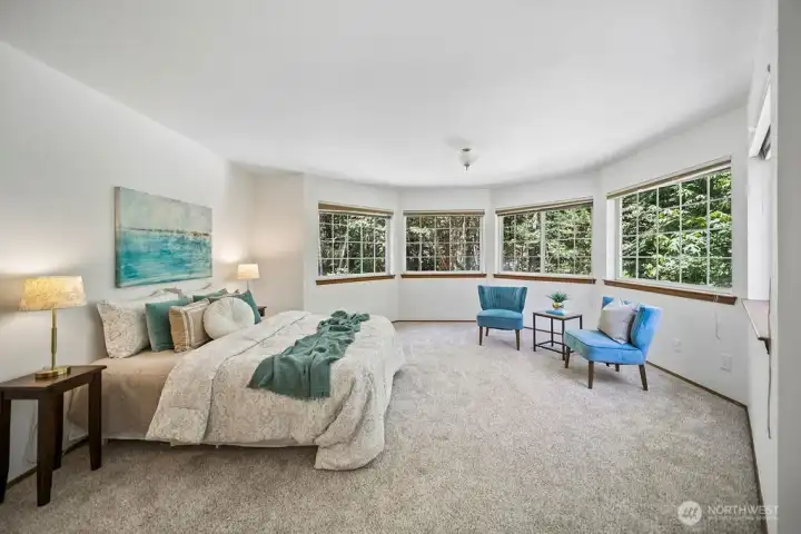 Generously sized primary bedroom with attached ensuite and walk in closet has view of the pond & lazy reiver just outside these windows.