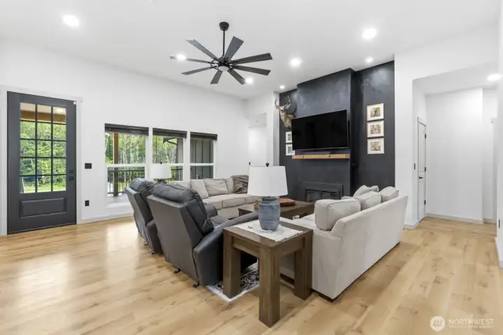 Living room as viewed from the front entry. Door pictured opens onto the back deck and patio area.
