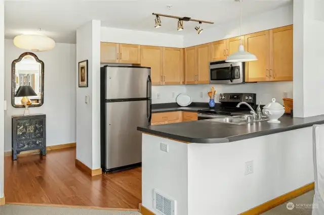 Kitchen with bar top seating.