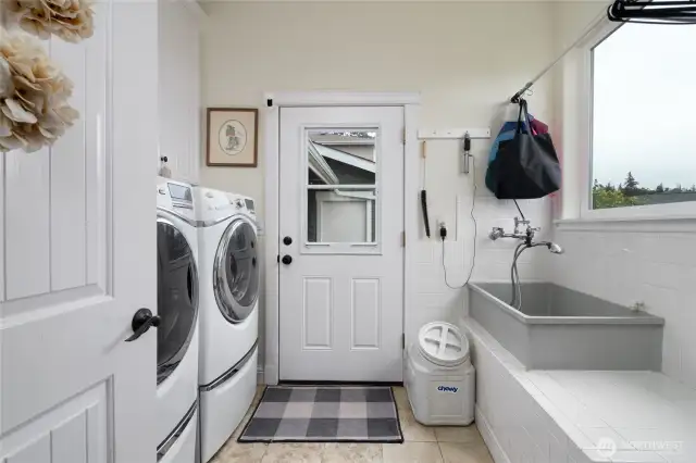 laundry room with dog washing station and plenty of storage space