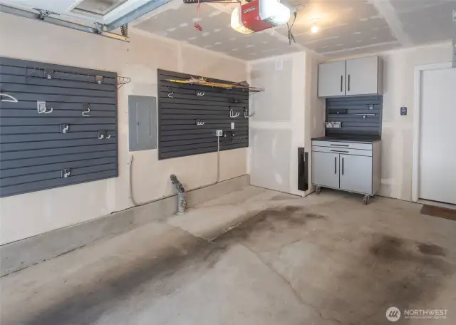 Attached Garage with Lots of Built in Shelving, Workbench, & EV Charger Ready