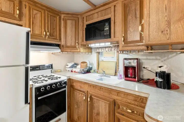 Kitchen with full size fridge.
