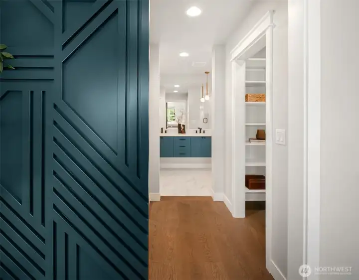 view of walk-in closet and bathroom in primary suite.
