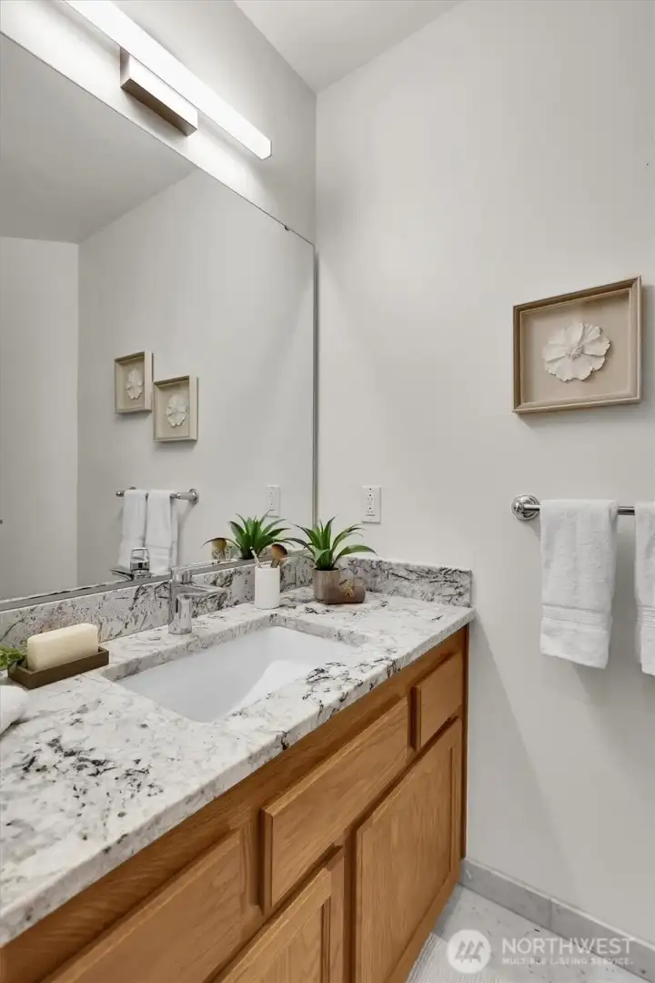 Remodeled main floor guest bath features marble flooring, granite counters and luxury bidet