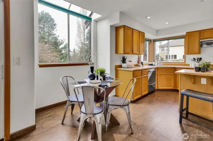 Spacious kitchen with SS appliances open up to informal kitchen nook